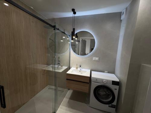 a bathroom with a washing machine and a sink at Teresin Nest in Teresin