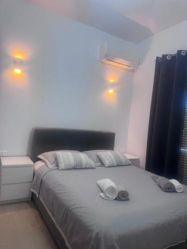 a bedroom with a bed with two towels on it at Maria House in Artemida
