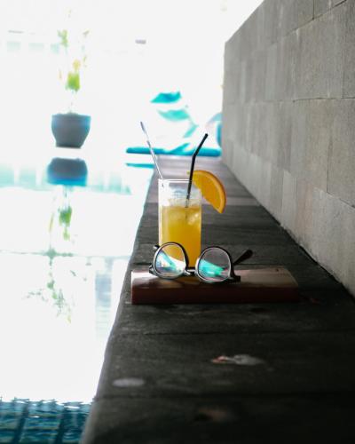 a drink with a pair of glasses and an orange slice at Best Western Premier La Grande Bandung in Bandung