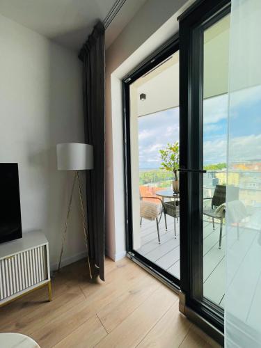 a room with a sliding glass door with a view of a patio at Sunrise Euronia in Międzyzdroje