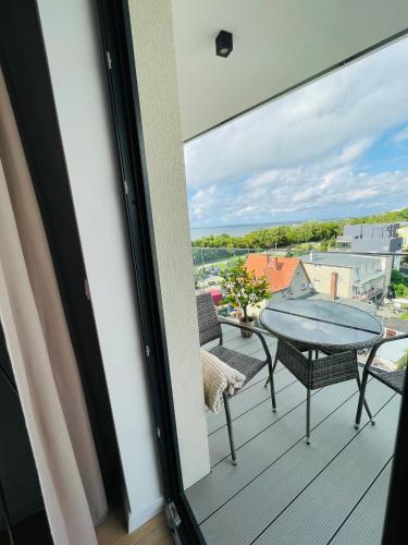 a balcony with a table and chairs and a view at Sunrise Euronia in Międzyzdroje