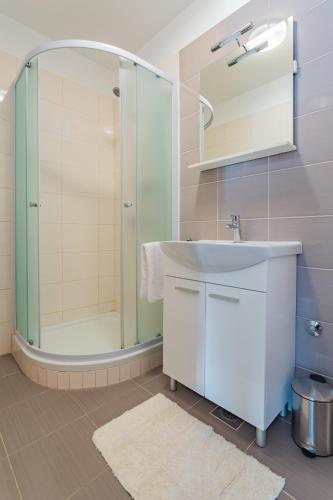 a bathroom with a sink and a shower at Apartment Bonaca in Posedarje