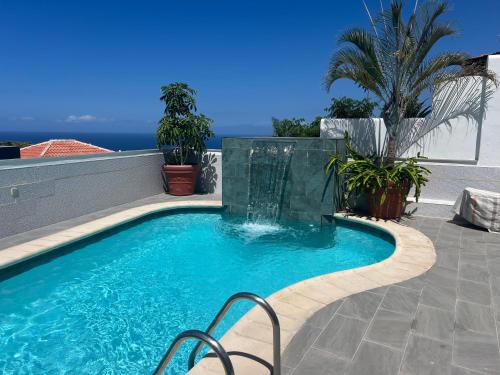 a swimming pool on the side of a house at Adeje Deluxe Villas Santa Mónica in Adeje