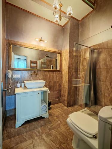 a bathroom with a sink and a toilet at Noblesse Palace Old Town by NF in Bucharest
