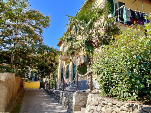 a building with a palm tree next to a street at SOTTO LA ROCCA in Finale Ligure