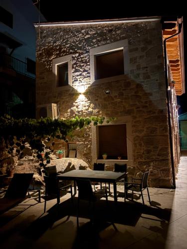 a table and chairs in front of a stone building at La Tahona in Fermoselle