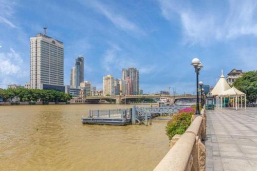 a view of a river with a city in the background at Yimimi Apartment - Guangzhou 13th Line Yide Road Metro Station in Guangzhou
