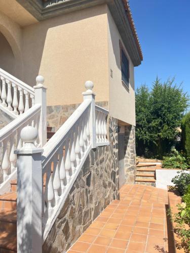 a house with a white railing and a staircase at El Chalete in Otura