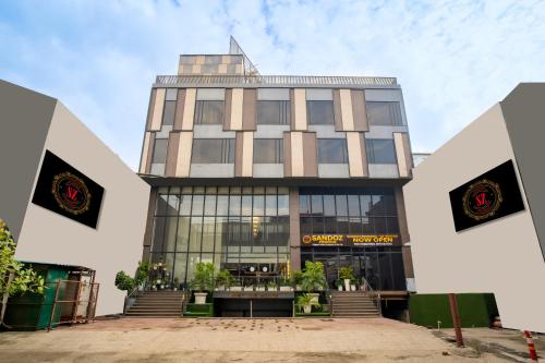 a tall building with a lot of windows at SANDOZ Pribson Hotel near Golden Temple in Amritsar