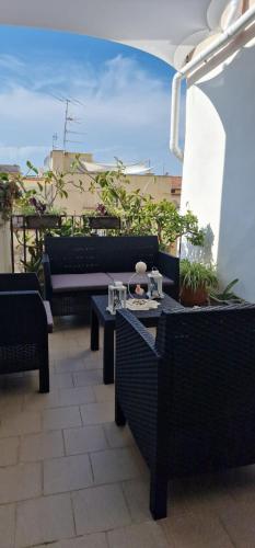 a patio with chairs and tables on a balcony at Garghe House in Sorrento