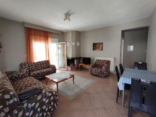 a living room with a couch and a table at Elena's Apartment in Nea Fokea