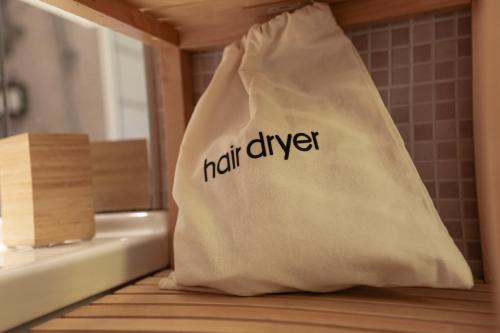 a white bag with the word half diver written on it at MaMa Rooms and Apartment in Rome