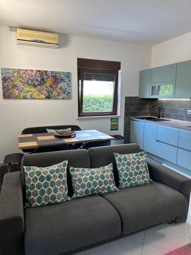 a living room with a couch and a kitchen at Apartments Zlatko & Mira Dorcic in Baška