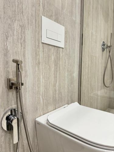 a bathroom with a white toilet and a shower at Elis Apartment in Tirana