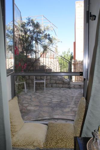 a view of a patio from the door of a balcony at Artists' Colony Inn Zefat in Safed