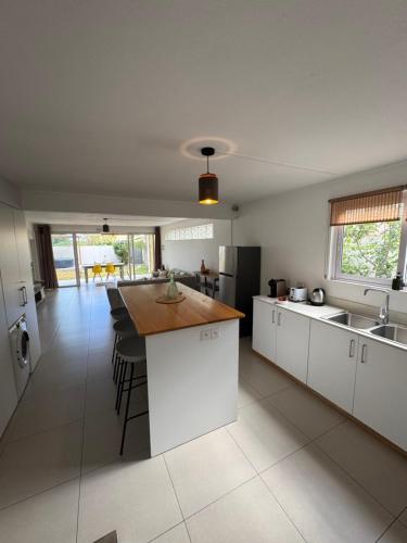 a kitchen with white cabinets and a wooden counter top at Le Nid du Dodo in Albion