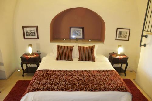 a bedroom with a large bed with two night stands at Artists' Colony Inn Zefat in Safed
