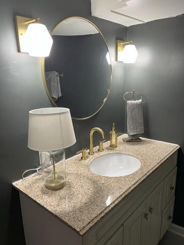 a bathroom with a sink and a mirror at Ripple Avenue Suites Suite B in Indianapolis