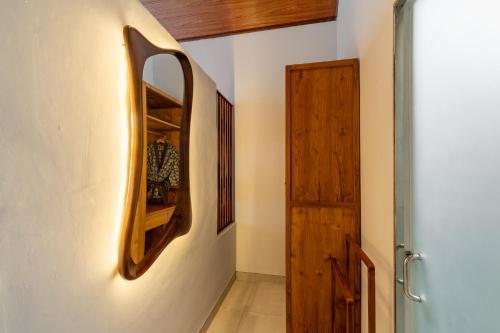 a hallway with a wooden shelf on the wall at Greha Natha Villa Ubud in Ubud