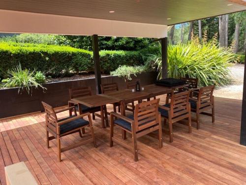 a wooden table and chairs on a wooden deck at Best of Yarra Valley and Kinglake National Park 