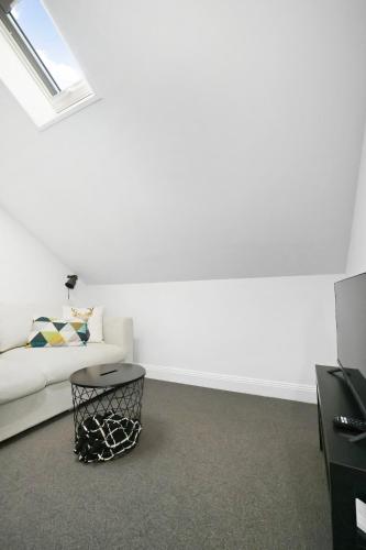 a white living room with a couch and a table at Best of Yarra Valley and Kinglake National Park 