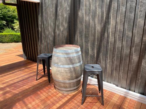 a barrel sitting on a deck with two stools at Best of Yarra Valley and Kinglake National Park 