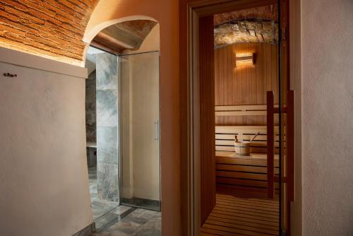 a door leading to a bathroom with a tub at Relais Vignale & Spa in Radda in Chianti