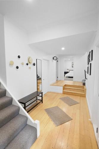 a white room with a staircase and a living room at Best of Yarra Valley and Kinglake National Park 