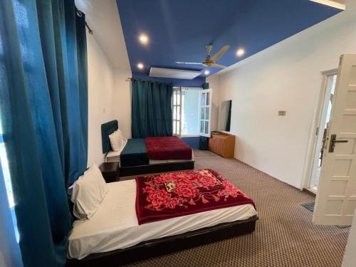 a bedroom with two beds in a room at Sarfaranga Residency in Skardu