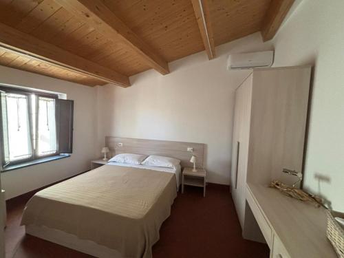a bedroom with a bed and a window at Sant'Elia B&B in Alessandria del Carretto
