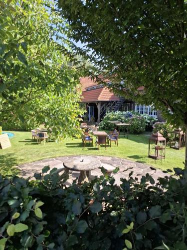 a park with a table and chairs in the grass at Aan de Molenberg in Broekhuizen