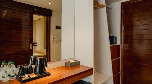 a room with a counter and a mirror in a room at The Scenic Hotel in Phnom Penh