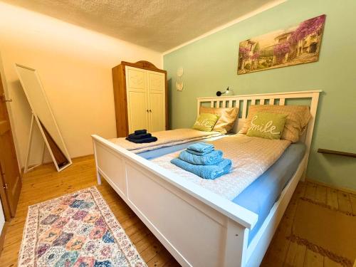 a bedroom with a bed with blue towels on it at Apartment - direkt am Fluss, balkon, rustikal, idylisch in Grünau im Almtal