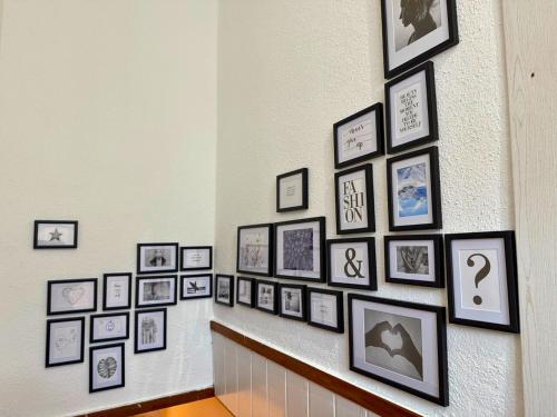a hallway with a bunch of pictures on a wall at Apartment - direkt am Fluss, balkon, rustikal, idylisch in Grünau im Almtal