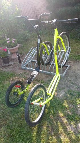 a yellow bike on a bike rack in the grass at Penzion Václav in Hnojní