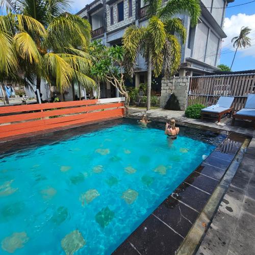 a woman in a swimming pool in a house at Ridho Malik Hotel in Bumbang