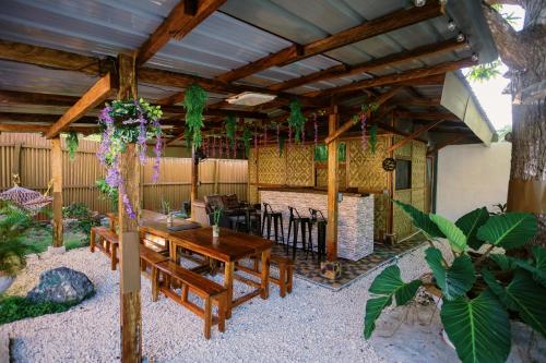 an outdoor patio with a wooden table and chairs at Selectum Mangrove Resort in Panglao