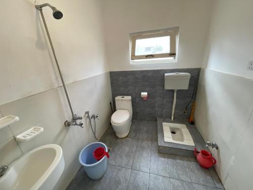 a small bathroom with a toilet and a sink at Sarfaranga Residency in Skardu