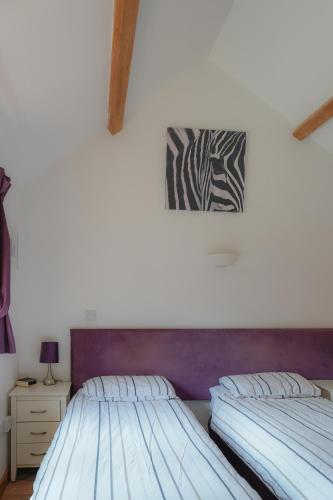 two beds sitting next to each other in a bedroom at Lakeview at Lodge Farm in Norwich