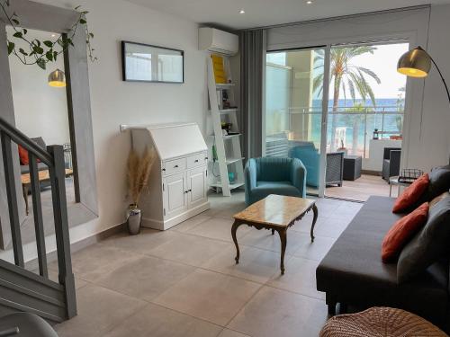 una sala de estar con un sofá y una mesa en La Prom 2 - a two bedroom apartment with a sea view, en Niza