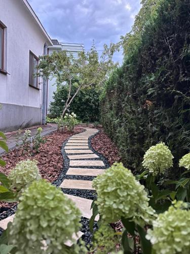 a garden with a stone walkway next to a building at Villa am Schwarzen Meer in Eforie Nord