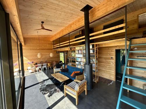 an open living room with a fireplace in a house at A country house with horses in Variku