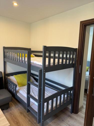 two bunk beds in a room with a mirror at Apartament i Pokoje Gościnne u Lusi in Wisła