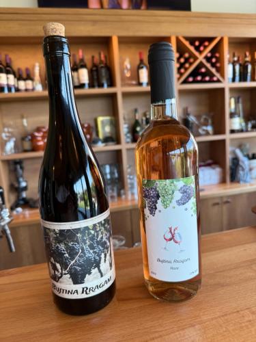 two bottles of wine sitting on a table at Bujtina Rragam in Rragam