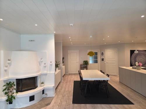 a living room with a table and a fireplace at Spacious home near Santa Claus Village in Rovaniemi