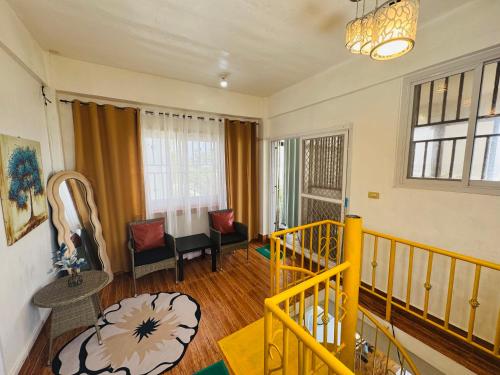 a living room with a yellow railing and a stairway at Villa Roco Private Beachfront Villa at Elyu in Bacnotan
