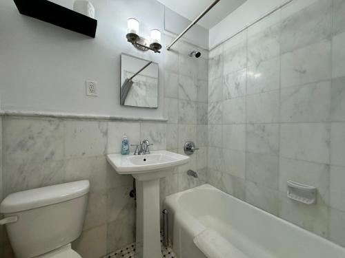 a bathroom with a sink and a toilet and a tub at Lincoln Center New York in New York
