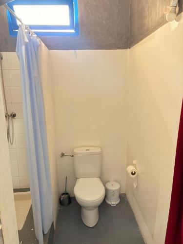 a small bathroom with a toilet and a window at ASARAG GUEST HOUSE & Lodge in Mirleft