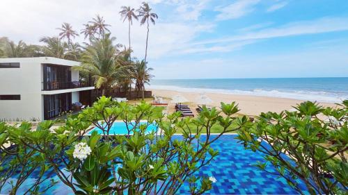 a resort with a swimming pool next to a beach at Lankavatara Ocean Retreat & Spa in Tangalle