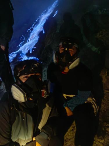 two people wearing diving gear sitting in a cave at Nio Homestay and Tour in Licin